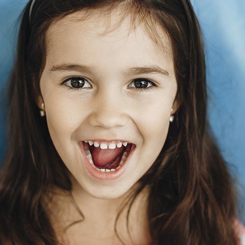 little girl wearing dental sealants