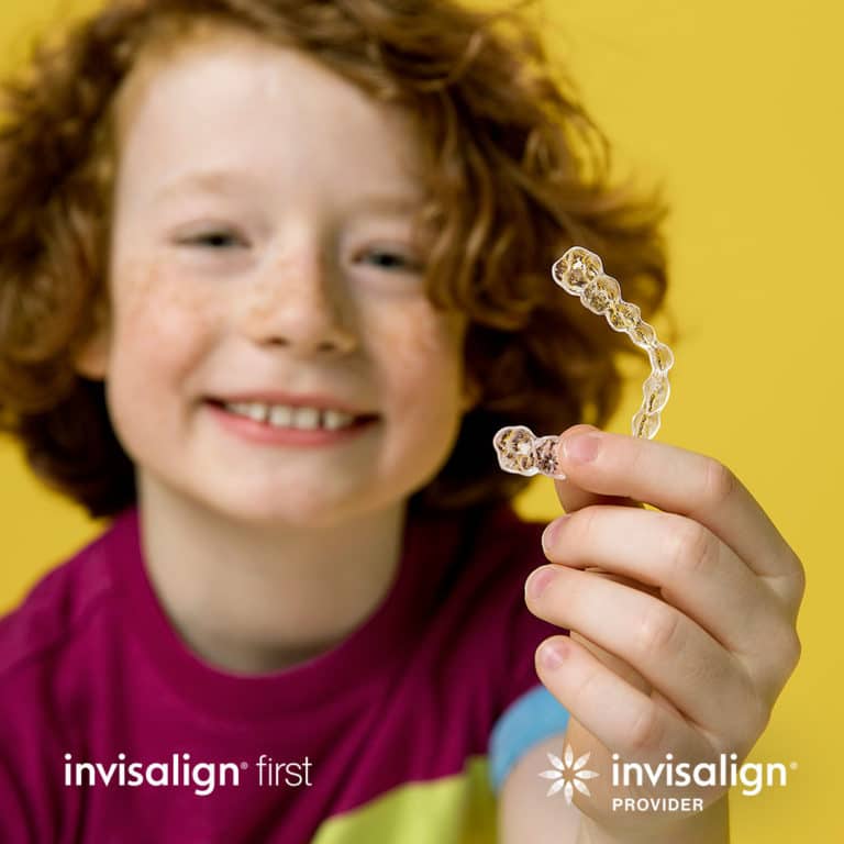 Kid holding invisalign